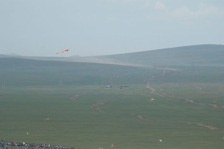 The dust cloud shows the horses almost to the valley