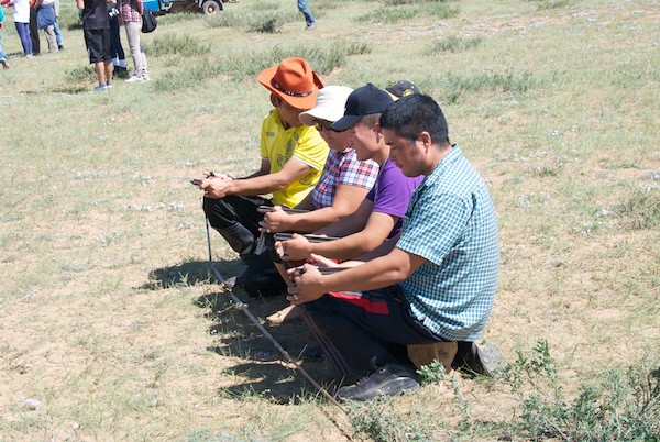 The competitors holding the piece of wood from which they launch an anklebone. You do not want to get hit by one