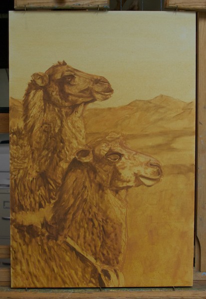 The next step is to bring up the dark values of the camels, referring to my drawing as needed.