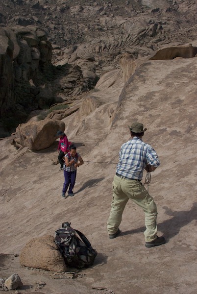 Magvandorj gives Odna a pull up the slope.