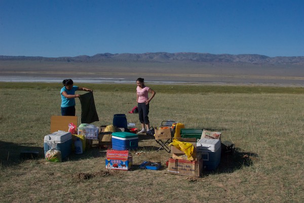 Soyoloo and Tseegii packing up the kitchen and food.