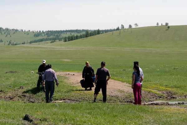 At one of them, which was more mud than water, a man and woman on a motorbike came along