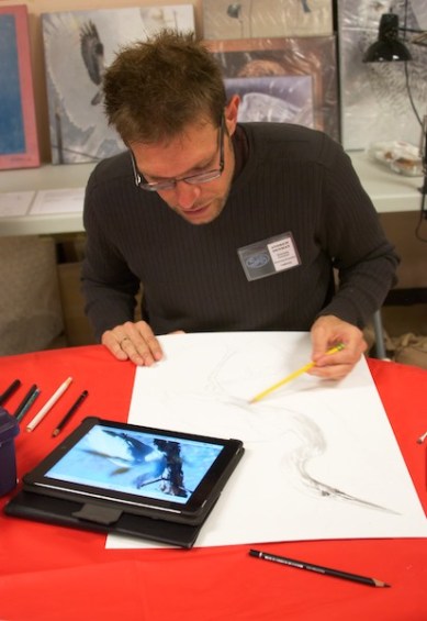 Andrew Denman working on a graphite drawing of an egret.