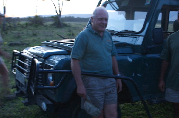 Simon Combes posing by one of the Land Rovers