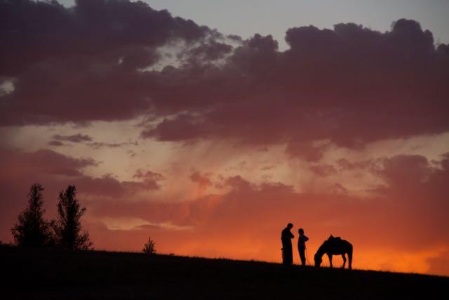 Two cousins watch the sunset