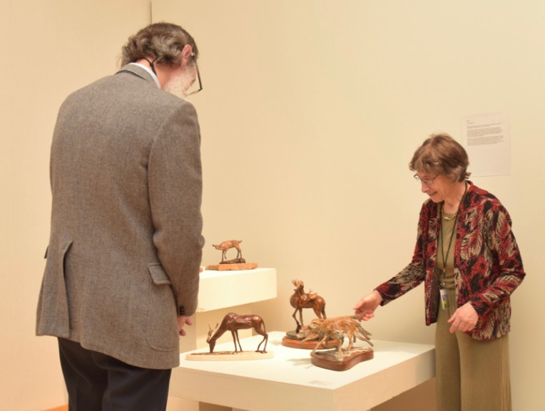 Karryl chats about her sculpture with a guest