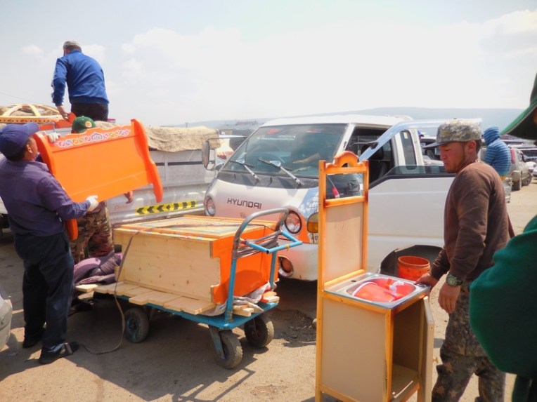 Delivering the furniture to the truck. 